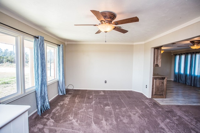 carpeted empty room with crown molding, ceiling fan, and a healthy amount of sunlight