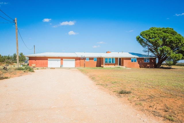 ranch-style home with a front yard and a garage