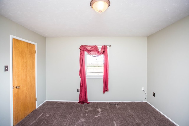 unfurnished room with carpet flooring and a textured ceiling