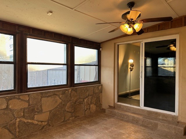 unfurnished sunroom featuring vaulted ceiling