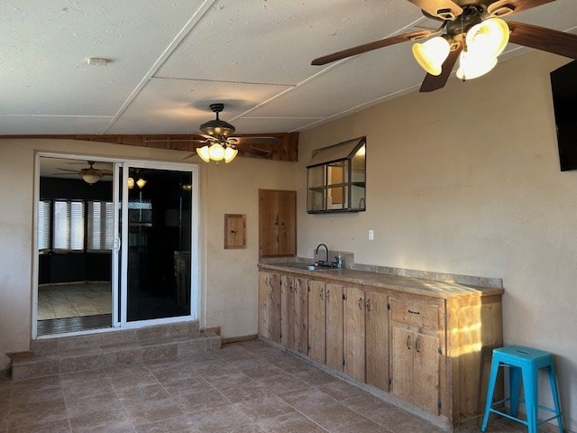 kitchen featuring a ceiling fan and a sink