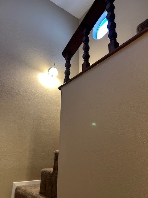 staircase with a textured wall