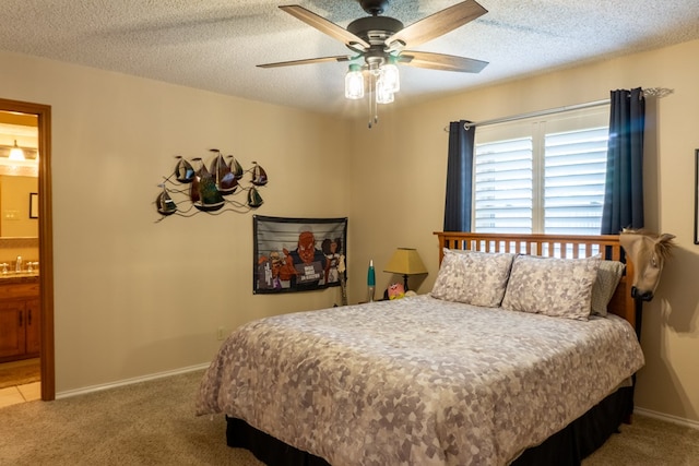 bedroom with carpet floors, a ceiling fan, a sink, and connected bathroom