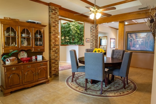 dining space with ceiling fan, crown molding, light tile patterned floors, baseboards, and ornate columns