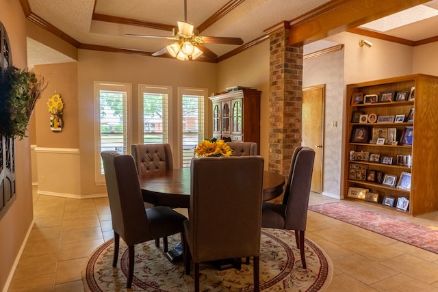 dining room featuring crown molding, decorative columns, and light tile patterned floors