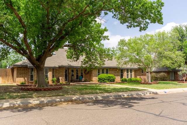 ranch-style house with brick siding and a front yard