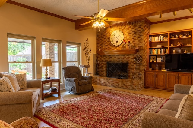 living area with a ceiling fan, a textured ceiling, a brick fireplace, light tile patterned floors, and ornamental molding