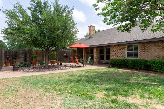view of yard featuring a patio and fence