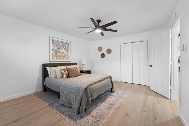 bedroom with light hardwood / wood-style floors, a closet, and ceiling fan