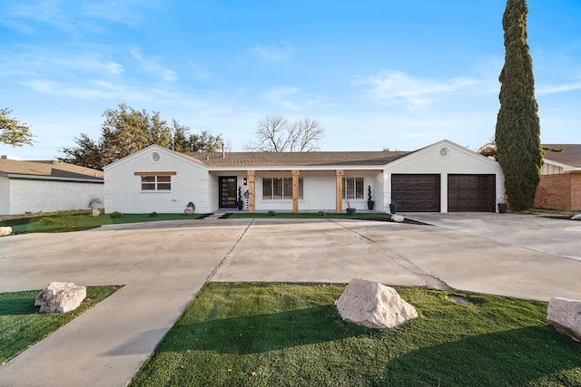 ranch-style home featuring a garage and a front yard