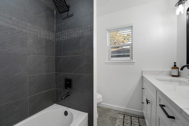 full bathroom featuring vanity, tiled shower / bath combo, and toilet