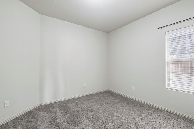 carpeted empty room with baseboards