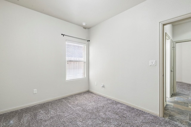 empty room with carpet and baseboards