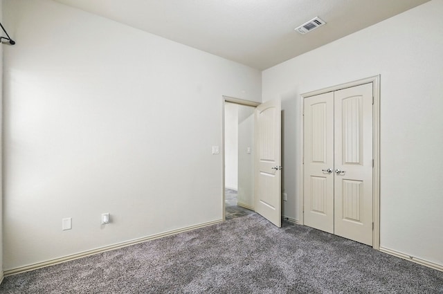 unfurnished bedroom featuring carpet and a closet