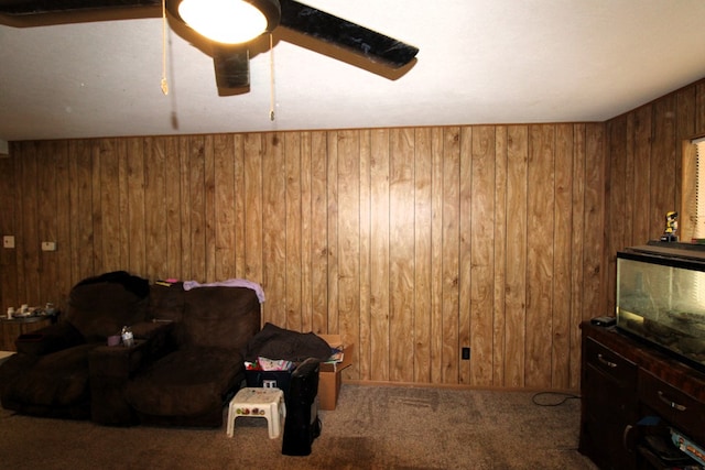 living room featuring wooden walls and carpet