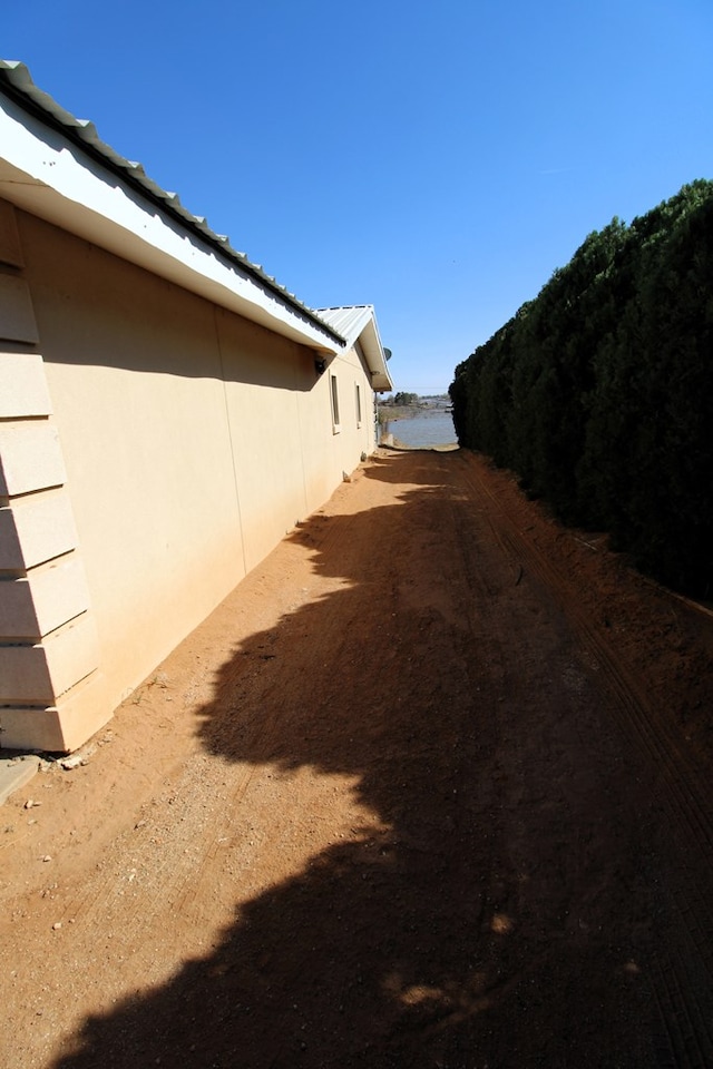 exterior space with metal roof and stucco siding