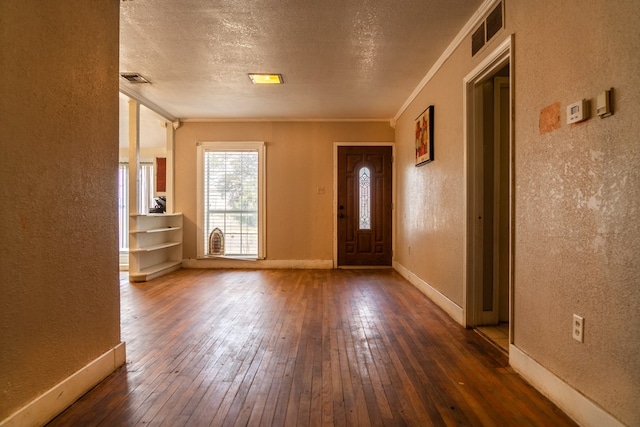 entryway featuring a textured ceiling, dark hardwood / wood-style floors, and ornamental molding