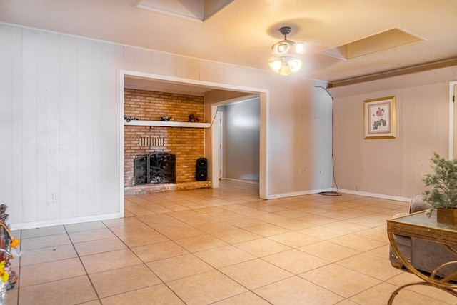 living room with a fireplace, light tile patterned floors, a textured ceiling, and wood walls