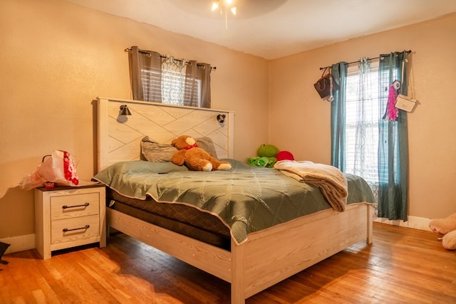 bedroom featuring ceiling fan and light hardwood / wood-style flooring