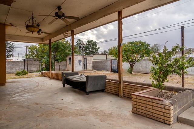 view of patio with ceiling fan and an outdoor structure