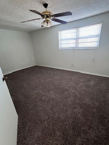 spare room featuring carpet floors, a wealth of natural light, and a textured ceiling