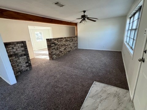 unfurnished living room with ceiling fan and carpet floors