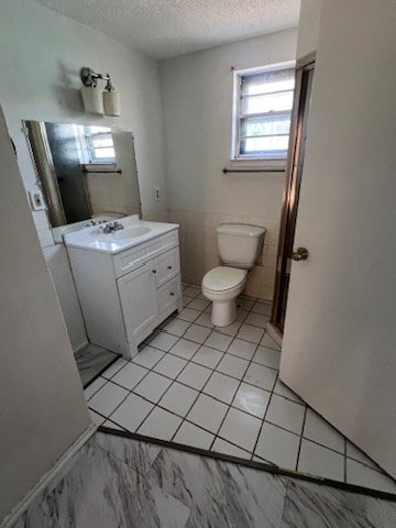 bathroom featuring vanity, toilet, and a textured ceiling