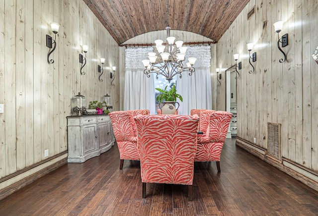 dining space with wood walls, dark wood-type flooring, and vaulted ceiling