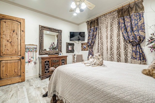 bedroom with light wood-type flooring, ceiling fan, and ornamental molding