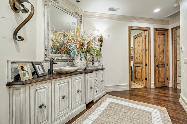 corridor with dark hardwood / wood-style floors and ornamental molding