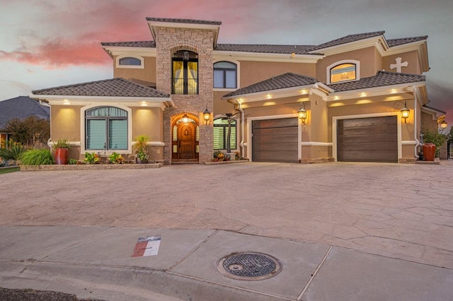 mediterranean / spanish home featuring a garage