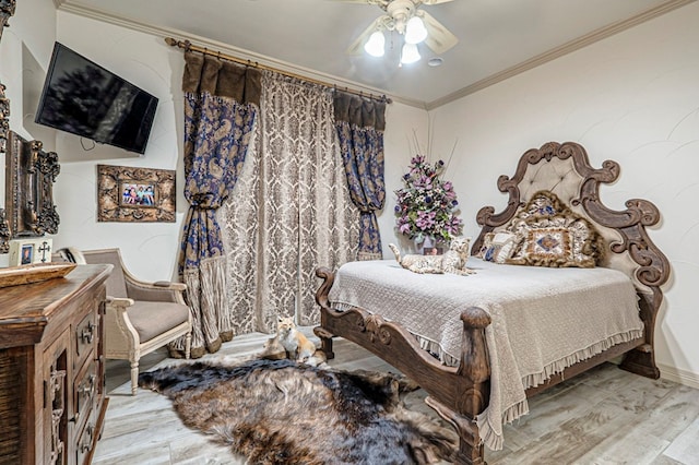 bedroom featuring ceiling fan, light hardwood / wood-style floors, and ornamental molding