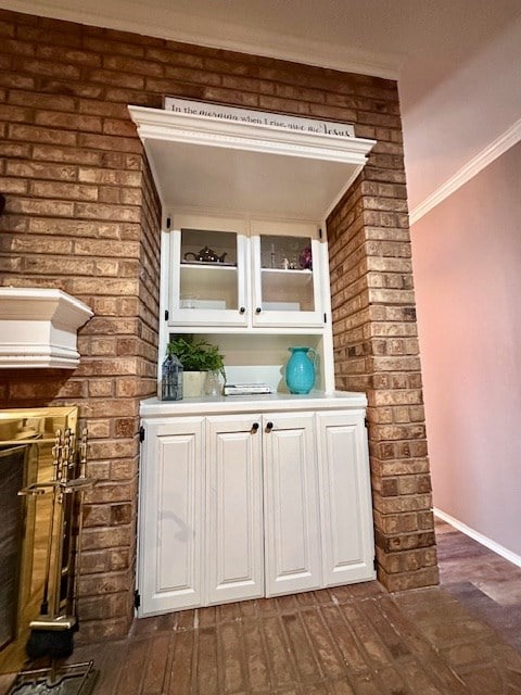 bar featuring crown molding and white cabinets