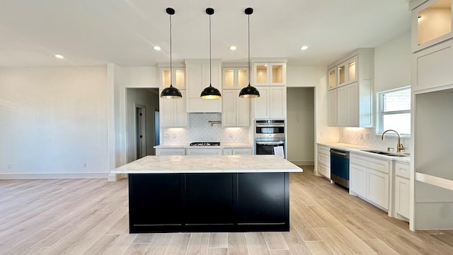2217 S County Rd 1059, Midland, TX 79706 - kitchen featuring stainless steel double oven, a sink, dishwasher, a center island, and decorative backsplash