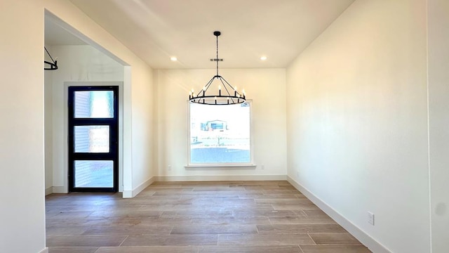 2217 S County Rd 1059, Midland, TX 79706 - foyer entrance featuring baseboards, plenty of natural light, wood finished floors, and a notable chandelier