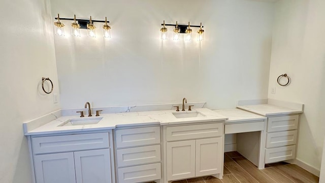 2217 S County Rd 1059, Midland, TX 79706 - bathroom with a sink, baseboards, double vanity, and wood finished floors