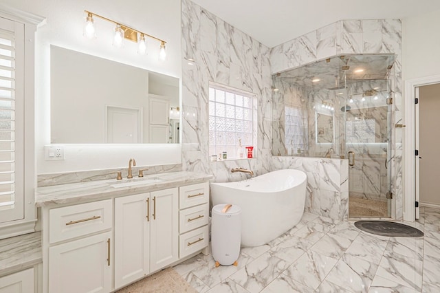 bathroom featuring marble finish floor, a freestanding bath, vanity, and a marble finish shower