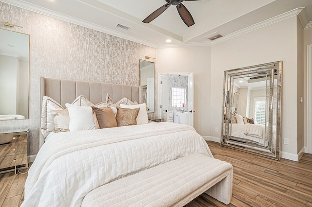 bedroom featuring baseboards, wood finished floors, and crown molding