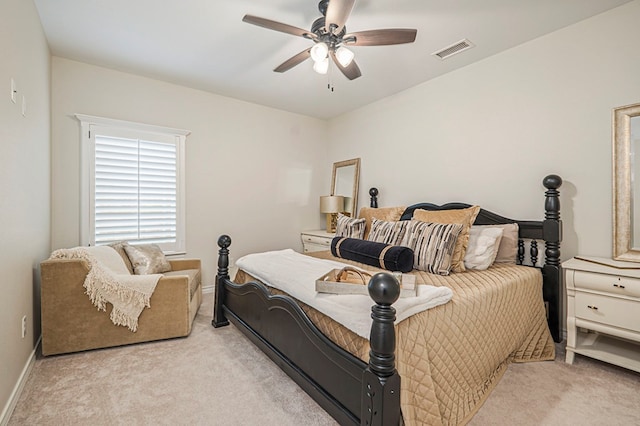 bedroom featuring baseboards, visible vents, and light colored carpet