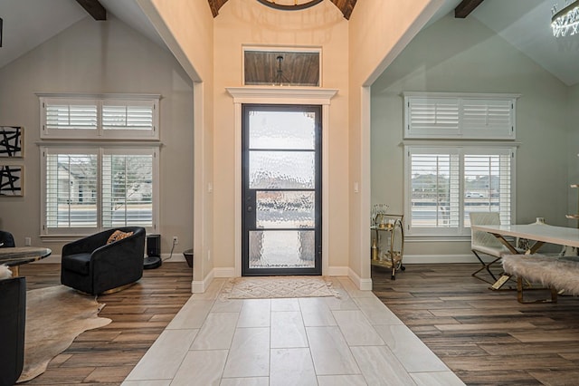 foyer with high vaulted ceiling, beamed ceiling, and a wealth of natural light