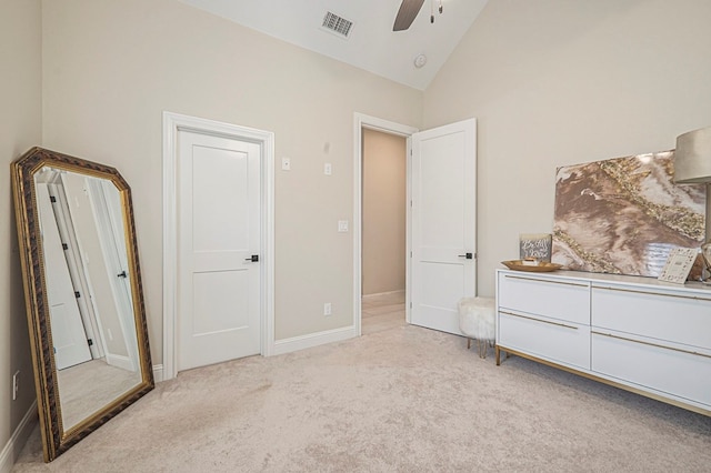 bedroom featuring light colored carpet, visible vents, a ceiling fan, high vaulted ceiling, and baseboards