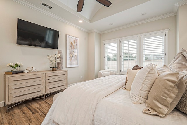 bedroom featuring lofted ceiling, recessed lighting, visible vents, ornamental molding, and wood finished floors