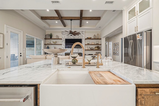 kitchen with coffered ceiling, white cabinets, glass insert cabinets, open floor plan, and freestanding refrigerator