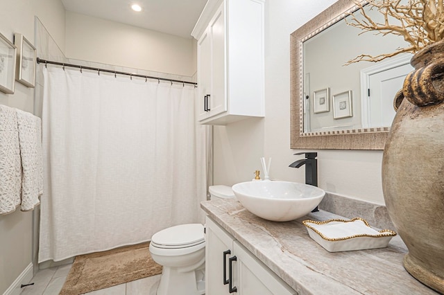 bathroom featuring toilet, tile patterned flooring, recessed lighting, and vanity