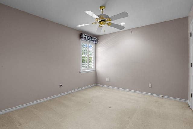 spare room featuring baseboards, light carpet, recessed lighting, and a ceiling fan