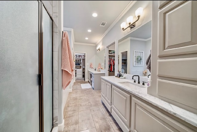 bathroom featuring wood-type flooring, vanity, walk in shower, and crown molding