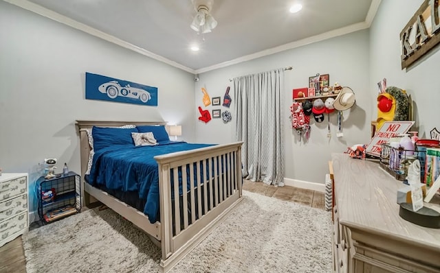 bedroom with crown molding and light hardwood / wood-style flooring