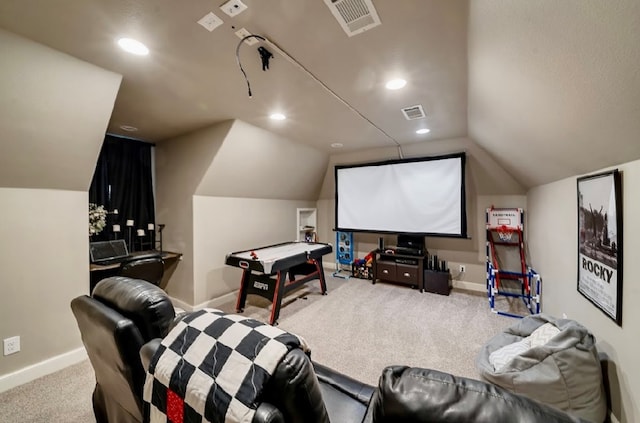 carpeted home theater room with vaulted ceiling