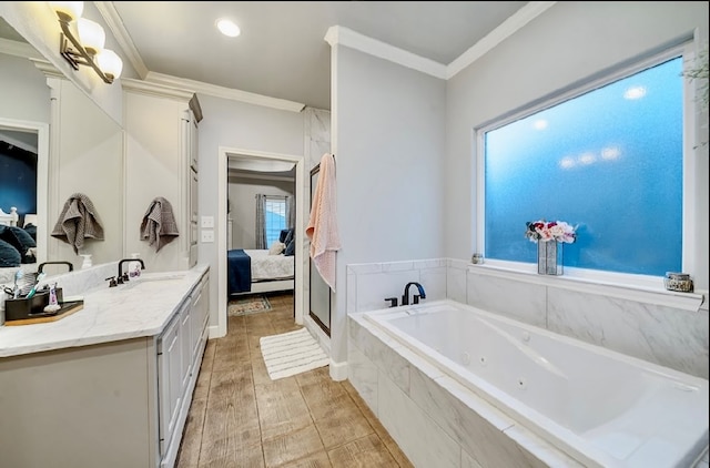 bathroom with hardwood / wood-style flooring, plenty of natural light, crown molding, and vanity