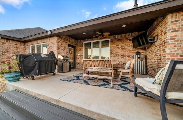 view of patio featuring area for grilling and ceiling fan